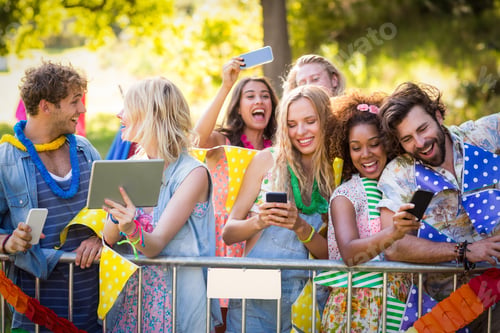 Preview: Friends Clicking Pictures From Their Mobile Phones And Digital Tablet In Park