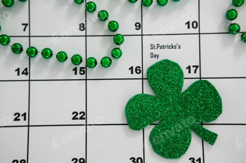Preview: St. Patricks Day Close-Up Of Shamrock And Beads Kept On Calendar