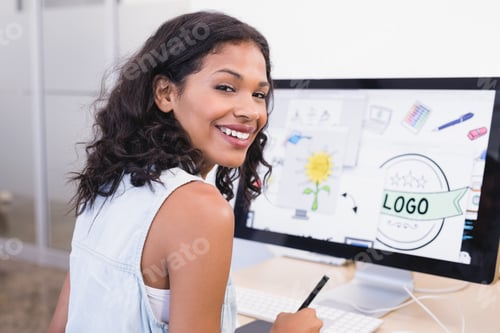 Preview: Smiling Businesswoman Using Desktop Computer While Working At Desk In Office