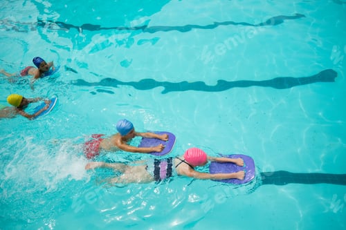 Preview: High Angle View Of Girls And Boys Using Kickboard While Swimming In Pool