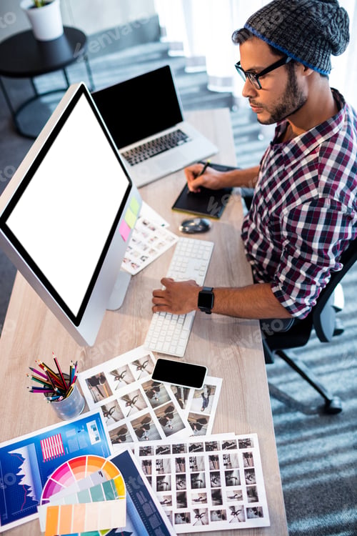 Preview: Photographer Working At Computer Desk In Studio