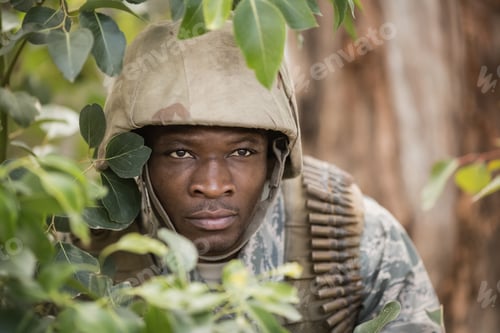 Preview: Close Up Of Military Soldier Hiding Behind Trees In Boot Camp