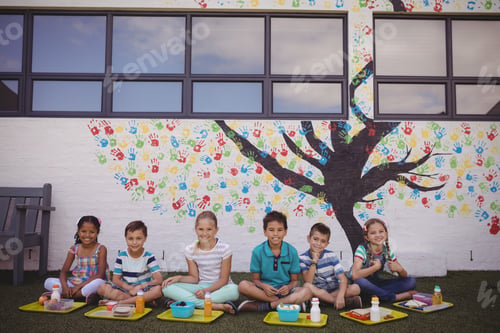 Preview: Portrait Of Happy Schoolkids Having Meal In School