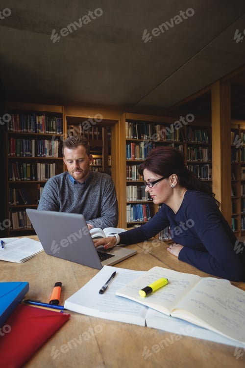 Preview: Mature Students Working Together With Laptop In College Library