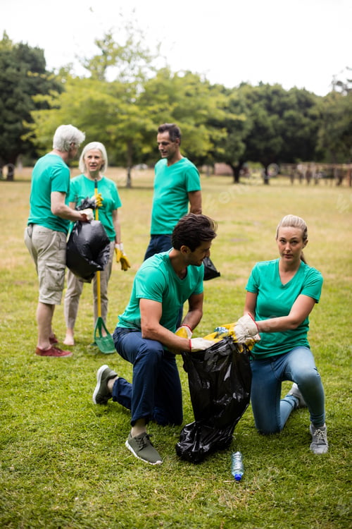 Preview: Team Of Volunteers Picking Up Litter In Park