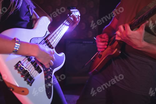 Preview: Mid Section Of Male And Female Guitarist Performing In Nightclub