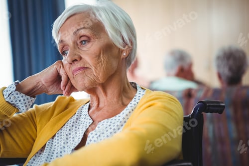 Preview: Senior Woman In Wheelchair Look Worried With Hand Holding Her Head