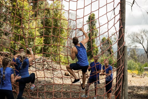 Preview: People Climbing A Net During Obstacle Course In Boot Camp