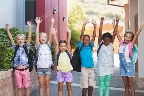 Preview: Group Of Happy Kids Standing In A Row With Hands Raised At School Campus