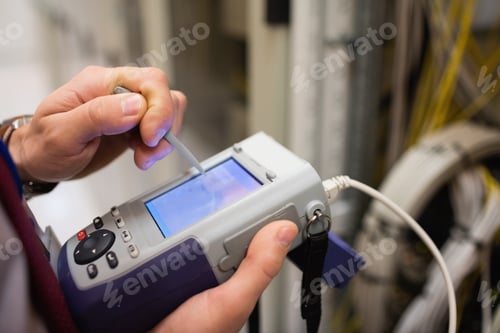 Preview: Mid Section Of Technician Using Digital Cable Analyzer In Server Room