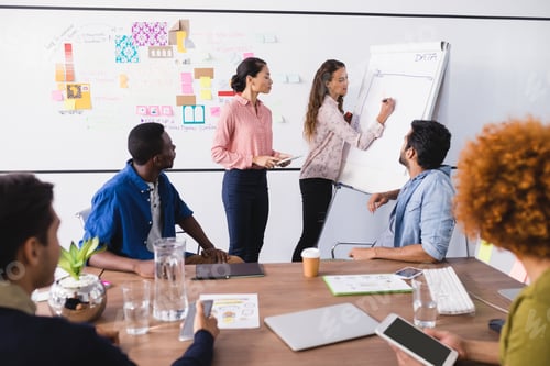 Preview: Young Business People Discussing While Working In Office