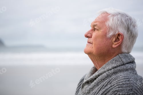 Preview: Thoughtful Senior Man Standing At The Beach