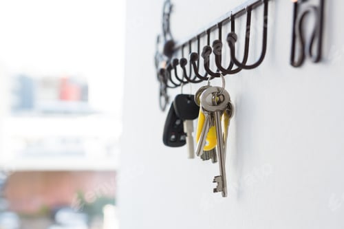 Preview: Close-Up Of Various Keys Hanging On Hook Against Wall