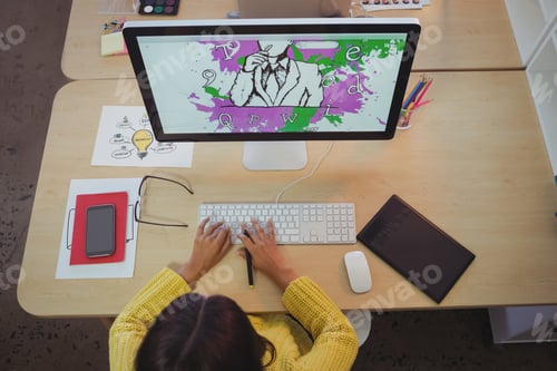 Preview: Overhead View Of Female Graphic Designer Working In Creative Office