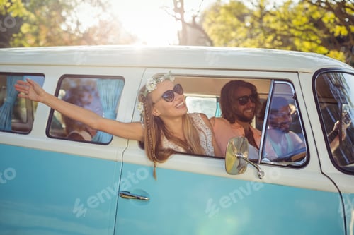 Preview: Smiling Woman Looking Out Of Campervan Window On A Sunny Day
