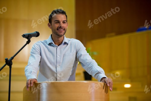 Preview: Business Executive Giving A Speech At Conference Center