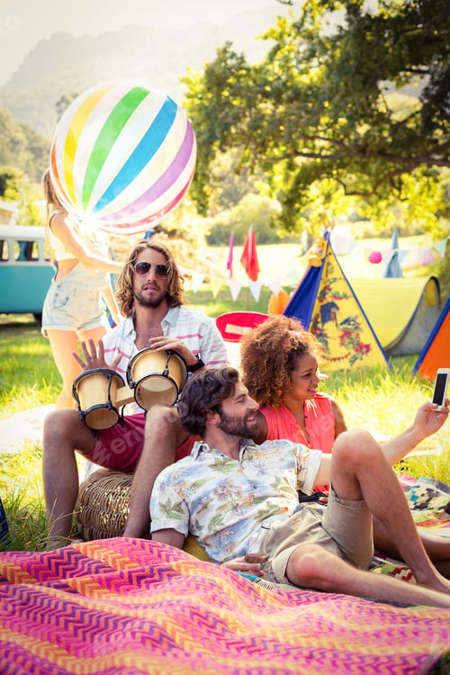 Preview: Friends Having Fun Together At Campsite On A Sunny Day