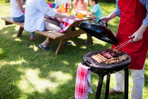 Preview: Mid Section Of Man Barbequing In The Park