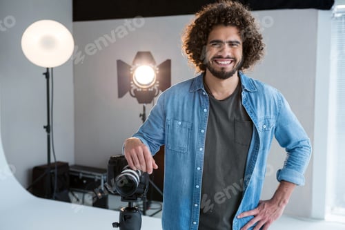 Preview: Portrait Of Happy Male Photographer Standing In Studio