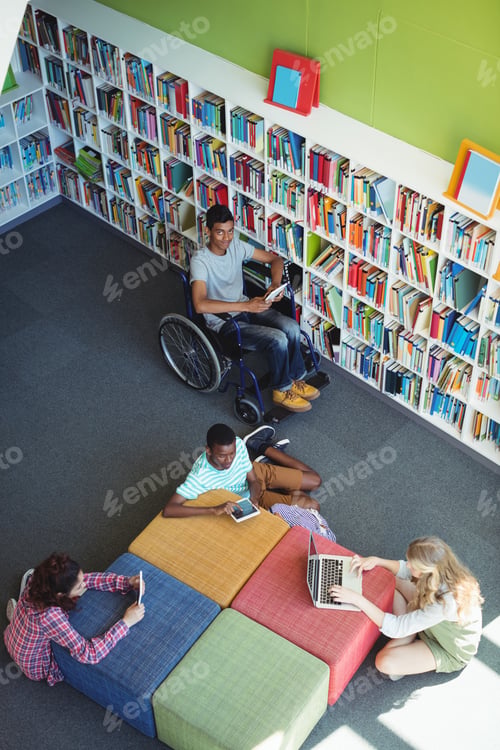 Preview: Overhead View Of Attentive Students Studying In Library At School