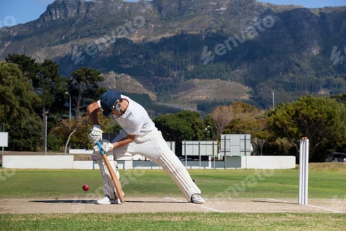 Preview: Full Length Of Batsman Playing Cricket On Field Against Mountain During Sunny Day