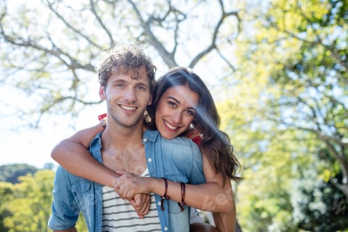 Preview: Portrait Of Young Couple Smiling And Embracing In Park On A Sunny Day
