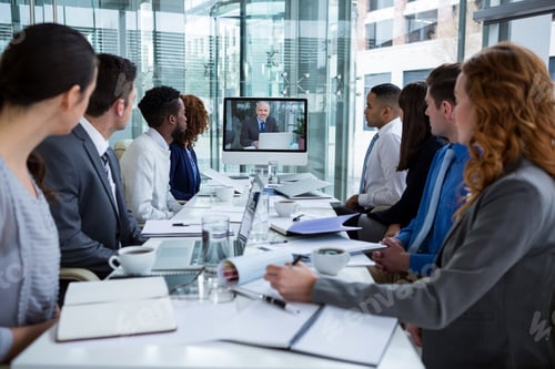 Preview: Business People Looking At A Screen During A Video Conference In The Conference Room