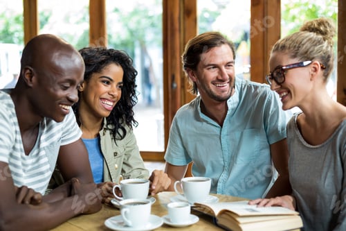 Preview: Happy Group Of Friends Interacting In Cafe