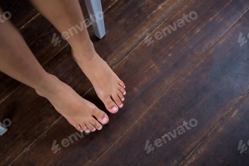 Preview: High Angle View Of Girl Sitting On Chair Over Hardwood Floor At Home