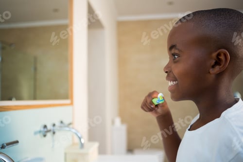 Preview: Side View Of Smiling Boy With Toothbrush In Domestic Bathroom