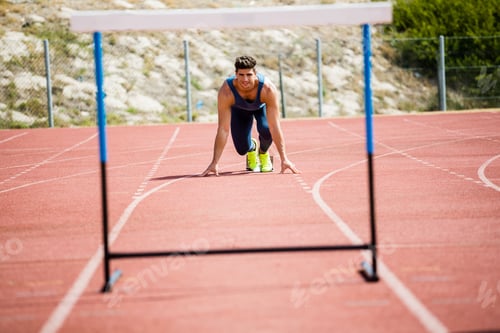 Preview: Athlete Ready To Jump A Hurdle On Running Track