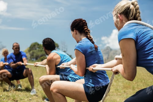 Preview: People Playing Tug Of War During Obstacle Training Course In Boot Camp