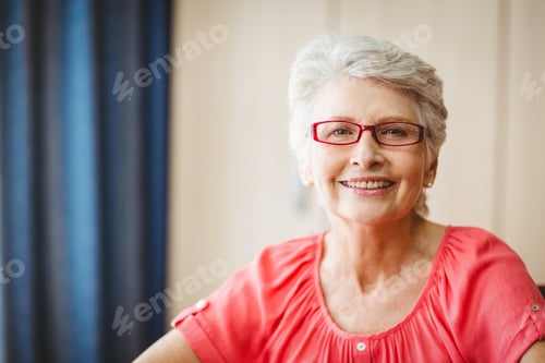 Preview: Smiling Senior Woman Portrait with Red Glasses Indoors