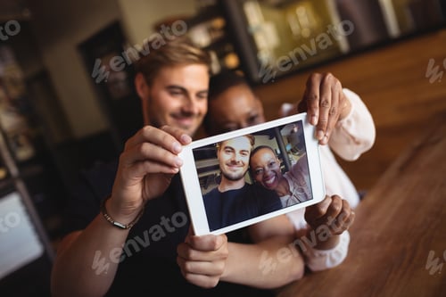 Preview: Happy Couple Taking Selfie From Digital Tablet In Restaurant