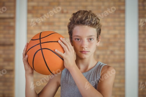 Preview: Determined Boy Holding A Basketball In The Court