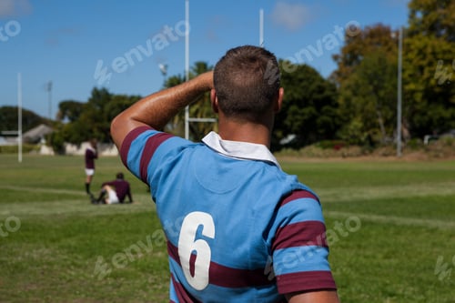 Preview: Rear View Of Rugby Player Standing At Playing Field