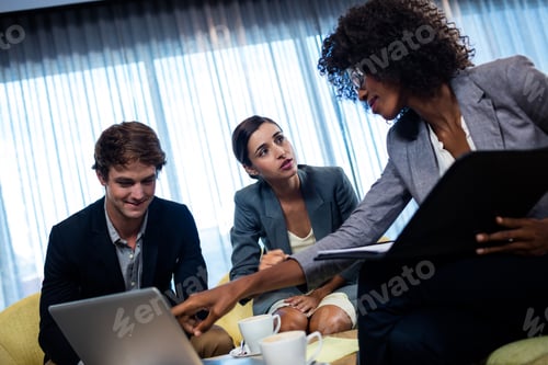 Preview: Coworkers Having Meeting Around Table In Studio