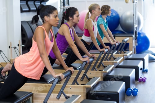 Preview: Group Of Women Exercising On Reformer In Gym