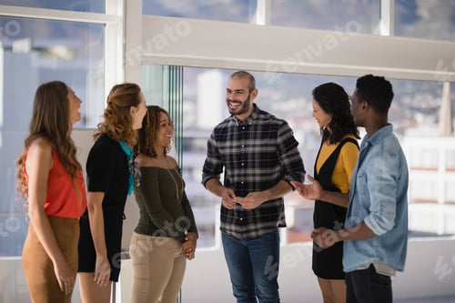 Preview: Group Of Colleagues Interacting With Each Other In Office