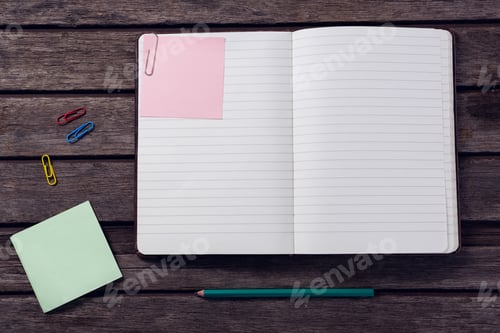 Preview: Overhead Of Diary, Sticky Notes, Pencil And Paper Clip On Wooden Table