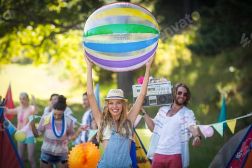 Preview: Woman Holding Beach Ball At Campsite On A Sunny Day