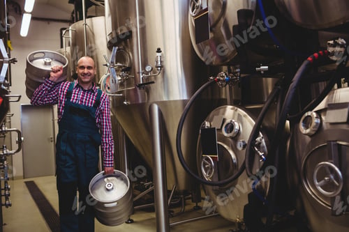 Preview: Portrait Of Brewery Worker Carrying Kegs At Factory