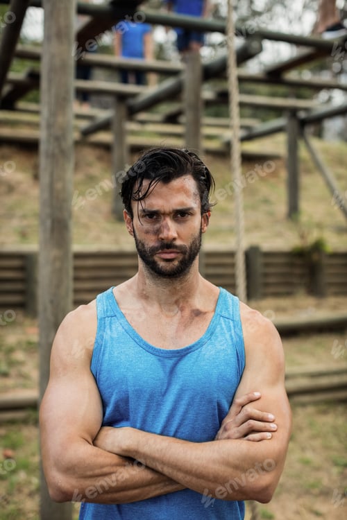 Preview: Portrait Of Determined Man Standing With Arms Crossed In Boot Camp Training During Day