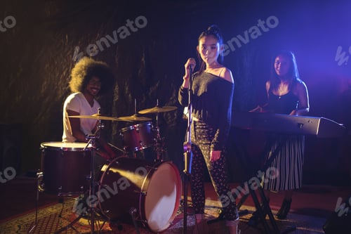 Preview: Portrait Of Confident Musicians And Singer Performing On Illuminated Stage In Nightclub
