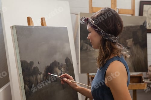Preview: Attentive Woman Painting On Canvas In Drawing Class