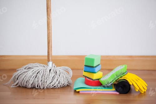 Preview: Mop And Cleaning Equipment On Wooden Floor Against Wall