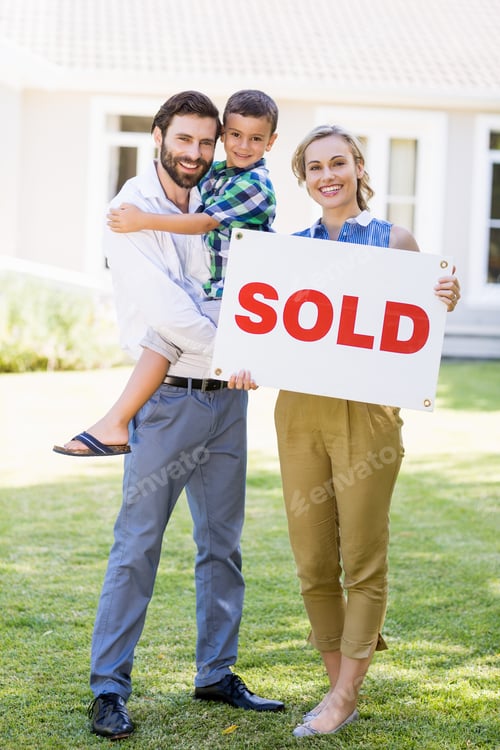 Preview: Portrait Of Happy Family Standing Outside Home With Sold Sign