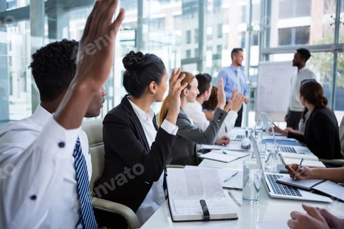 Preview: Colleagues Raising Their Hands During Meeting In Office