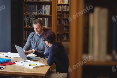 Preview: Mature Students Working Together With Laptop In College Library