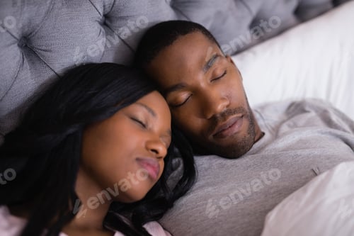 Preview: High Angle View Of Couple Sleeping Together On Bed At Home